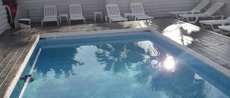 Seasonal outdoor pool, pool loungers