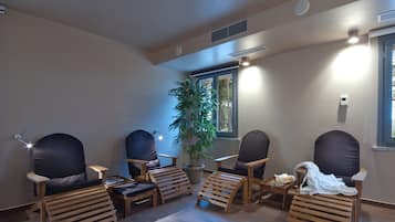 Relax in this stylish room with a large window, wooden furniture, and a cozy potted plant.