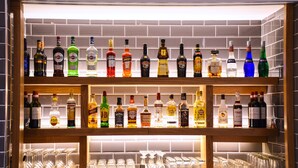 A bar area with multiple shelves of liquor bottles and glasses. - Holiday Inn Express Malta by IHG (St. Julian's)