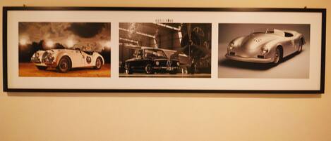 A framed collage of three vintage cars.