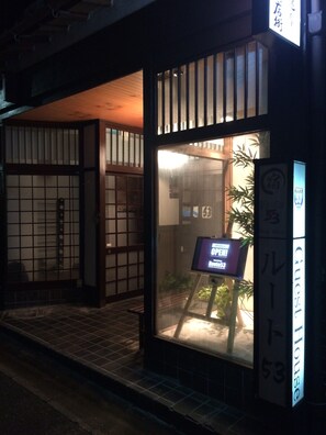 A traditional Japanese building with a sign indicating it's a guesthouse. - SUGIYA Guest House - Hostel (Nara)