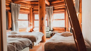 A cabin with two beds, wooden walls, and large windows. - Hakuba Log Hotel Meteor (Hakuba)