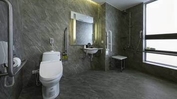 A modern bathroom with a toilet, sink, and shower.