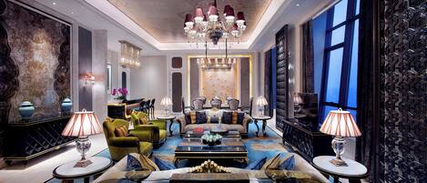 A luxurious living room with a chandelier, sofas, and a coffee table.