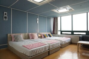 A room with two beds, a desk, and a large window. - Hongstay in Hongdae (Seoul)