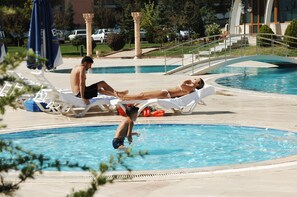 Seasonal outdoor pool, pool umbrellas, pool loungers