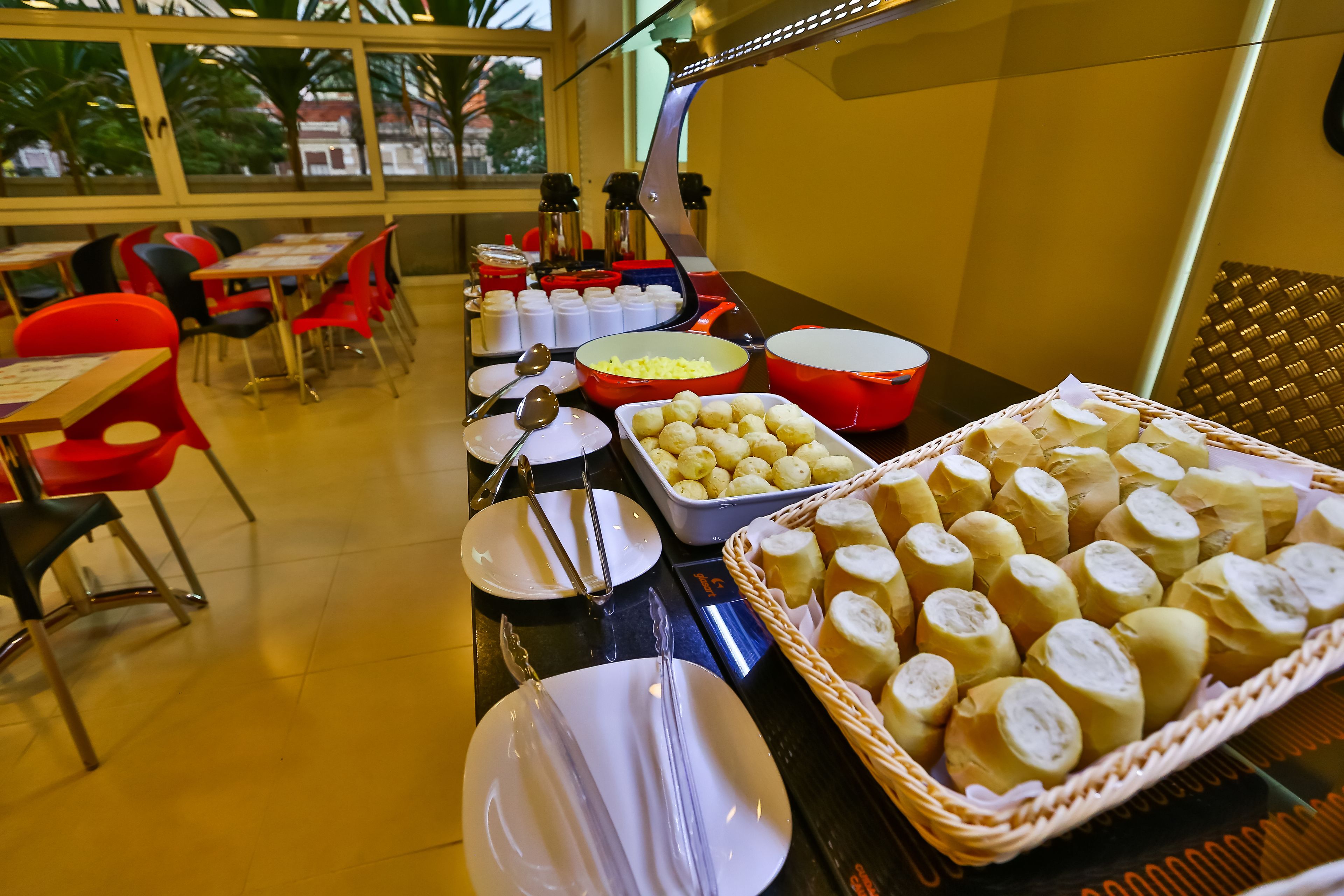 A buffet setup with various food items and utensils.