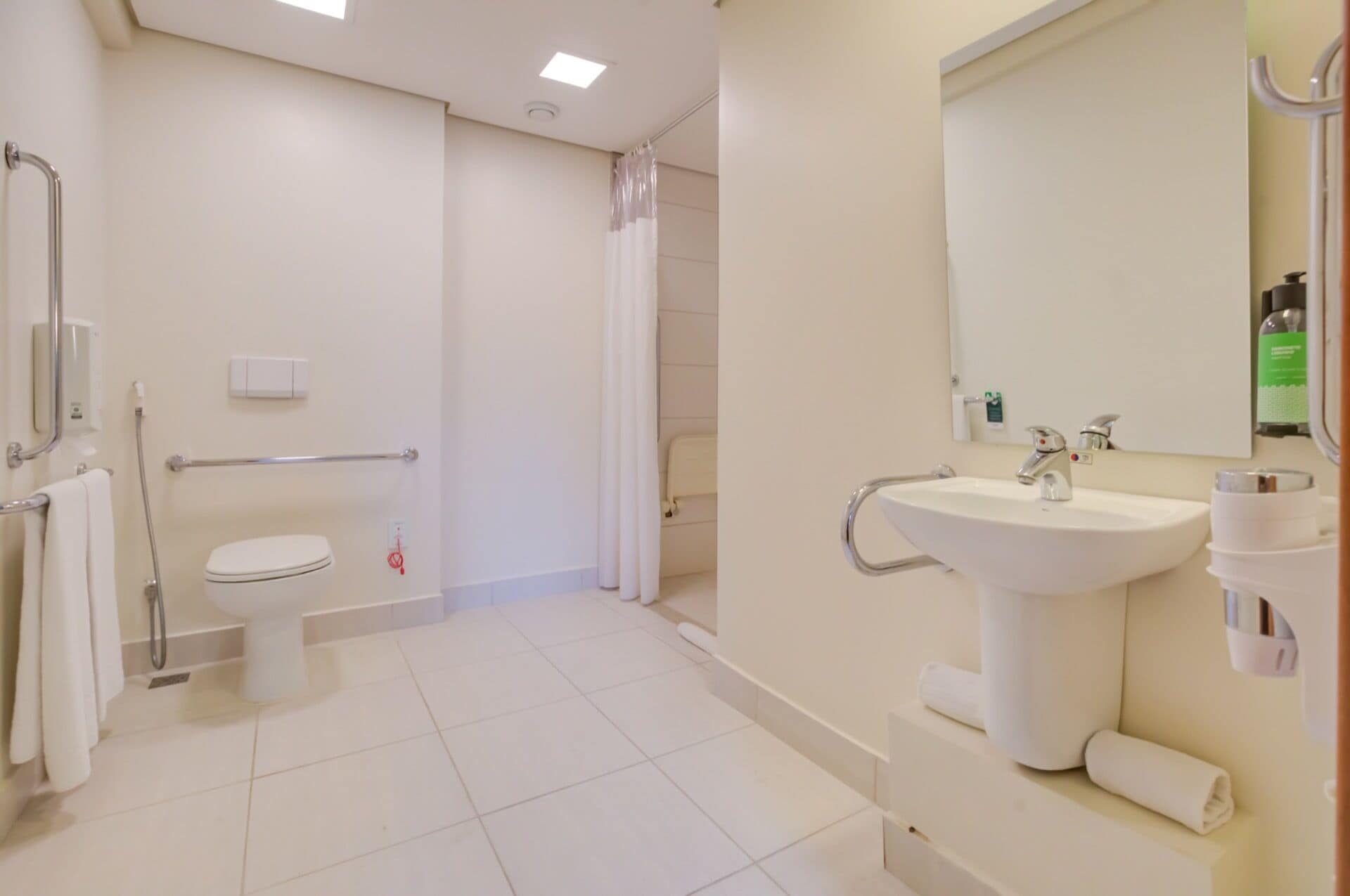 A modern bathroom with a toilet, shower, and sink.