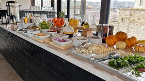 A buffet with various food items and condiments.