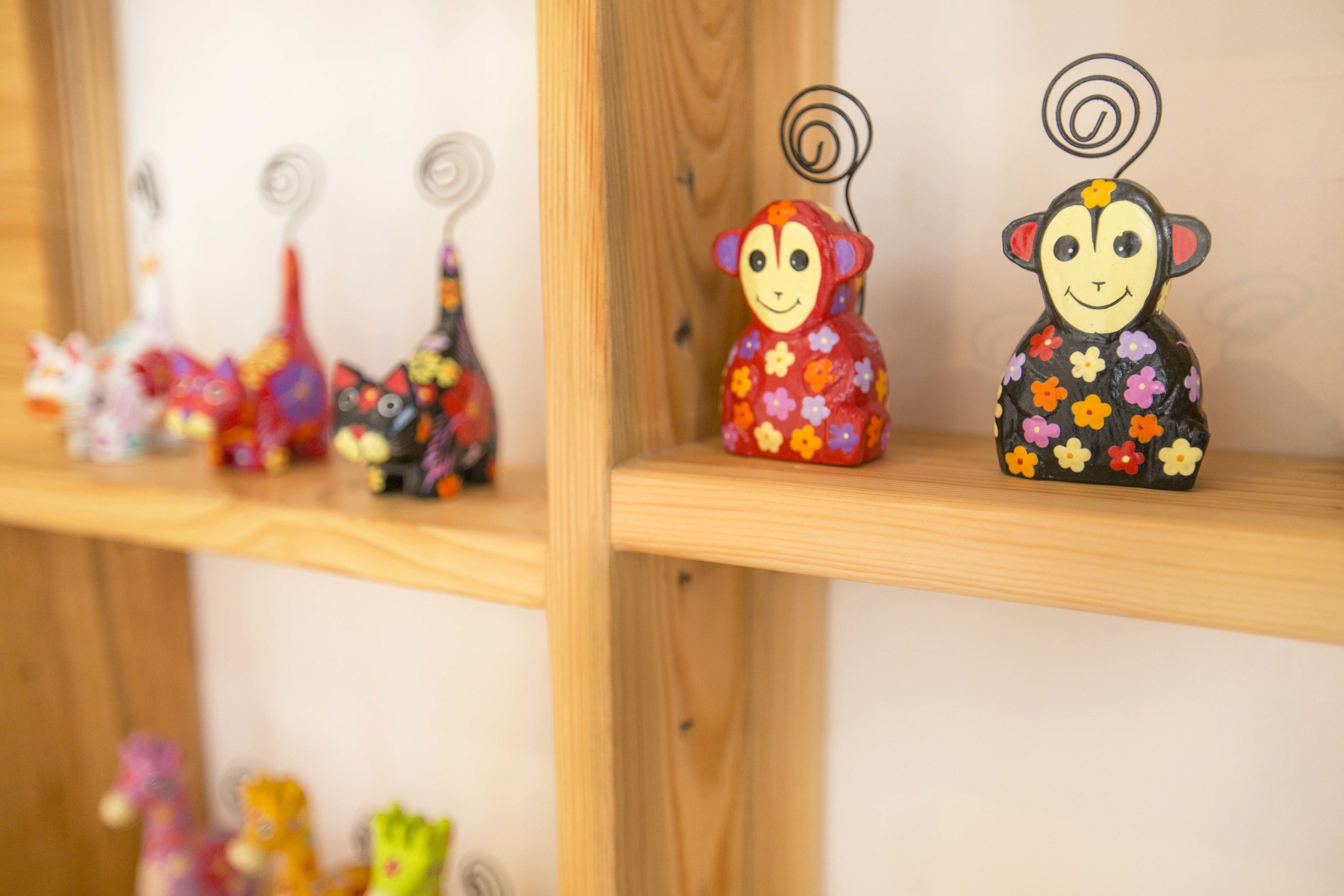 A shelf with various small figurines, including a monkey and a giraffe.