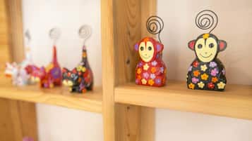 A shelf with various small figurines, including a monkey and a giraffe.