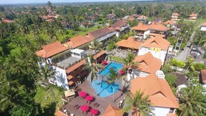 An aerial view of a resort with a swimming pool, multiple buildings, and surrounding greenery. - Best Western Premier Agung Resort Ubud (Ubud)