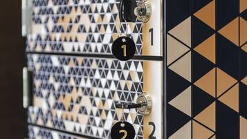 A wall with a geometric pattern and numbered locks, suggesting a secure storage or access system.