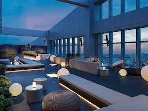 Relax and socialize in our rooftop lounge with expansive city views, comfortable seating, and ambient lighting.