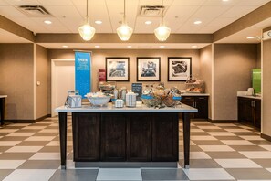 A breakfast bar with various food items and a sign that reads "TASTE FOR MIXER LAYER LAUGH."