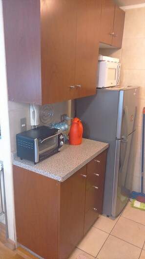 Standard Apartment, 1 Bedroom, Private Bathroom | Private kitchen | Fridge, microwave, oven, stovetop - Departamento Belen Marcoleta (Santiago)