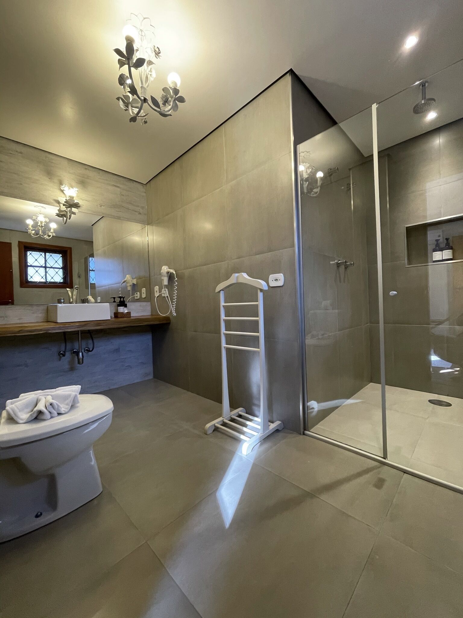 Une salle de bain moderne équipée de toilettes, d’un lavabo et d’un espace douche.