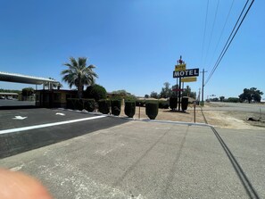 Welcome to Kings Rest Motel, situated in a semi-urban area with a parking lot.