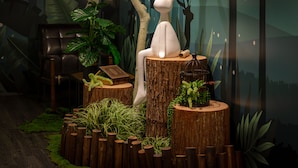 A stylized indoor scene with a white rabbit sculpture on a tree stump, surrounded by greenery and a mural in the background. - Finders Hotel-Fu Qian (Taipei)