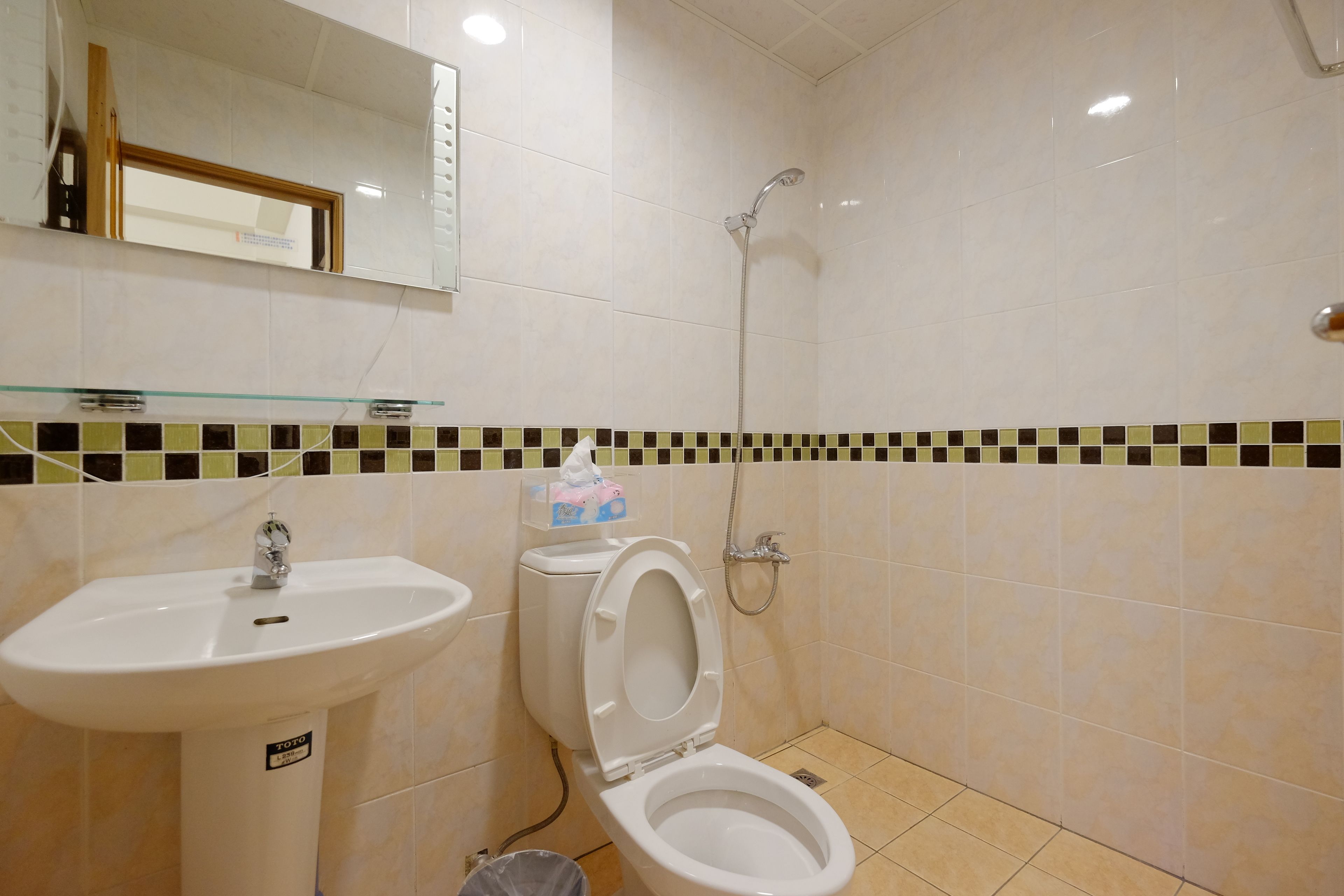 A bathroom with a sink, toilet, and shower.