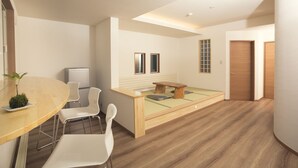 A modern, minimalist room with a wooden dining table, white chairs, a small wooden bench, and a bed with a green mattress. - Ryokan Mokuzin (Hakuba)