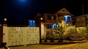 A gated property with a sign indicating it is a guest house. - Kuniville Guest House (Nyeri)