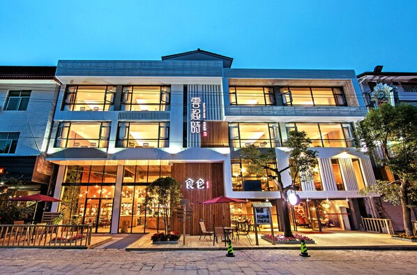 A modern building with large windows and a prominent entrance.