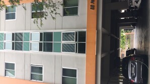 A multi-story building with a parking garage. - BB Place (Bangkok)