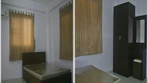 A room with a bed, a wardrobe, and a mirror. - BB Place (Bangkok)