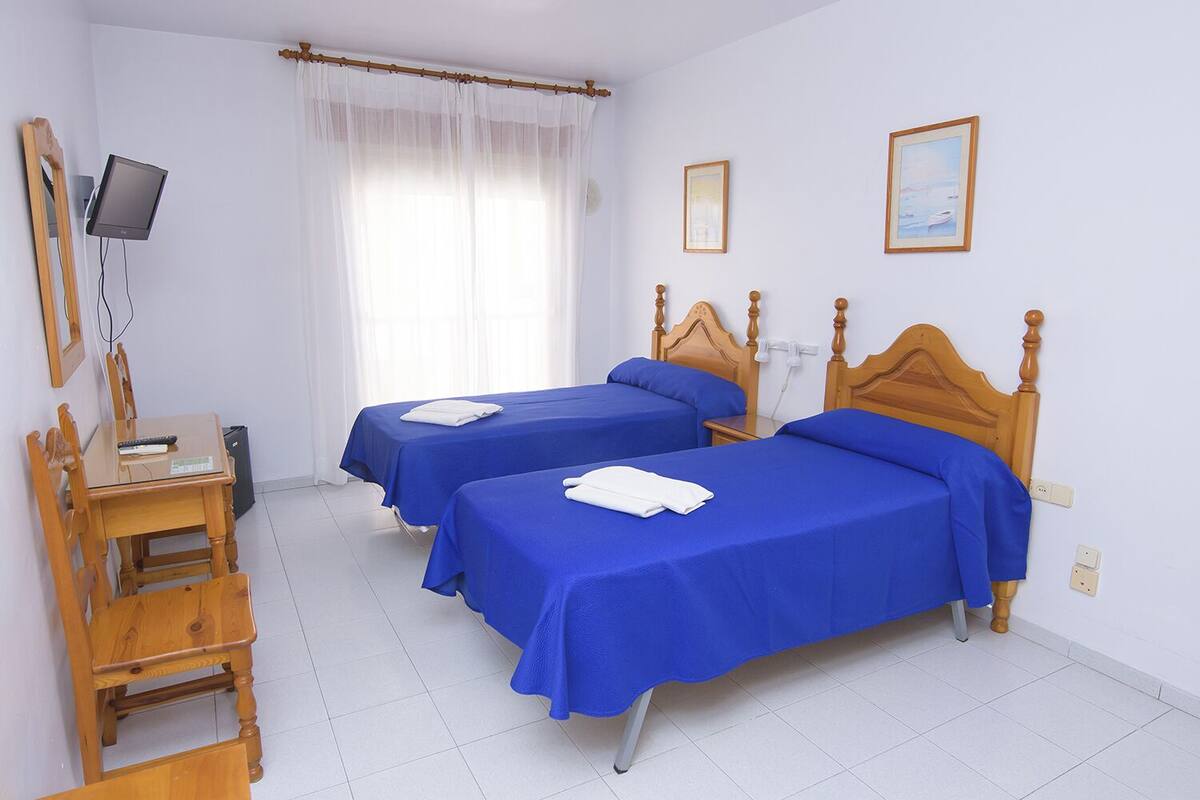 Twin Room | Desk, blackout drapes, iron/ironing board (on request), WiFi (free)