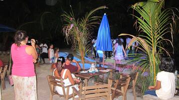 Enjoy al fresco dining under the shade of palm trees and umbrellas.