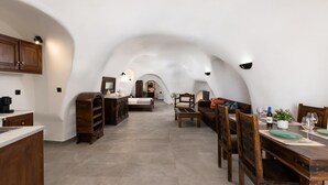 An arched ceiling with a kitchen, dining area, and bedroom.