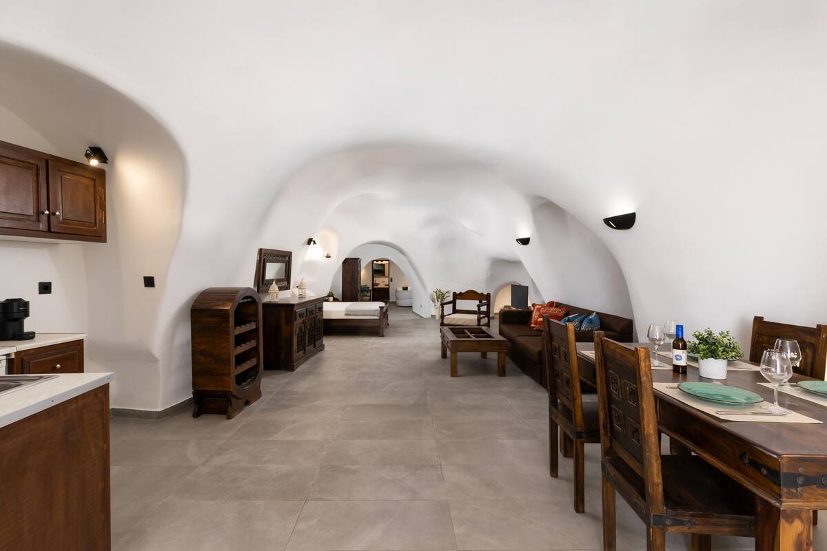 An arched ceiling with a kitchen, dining area, and bedroom.