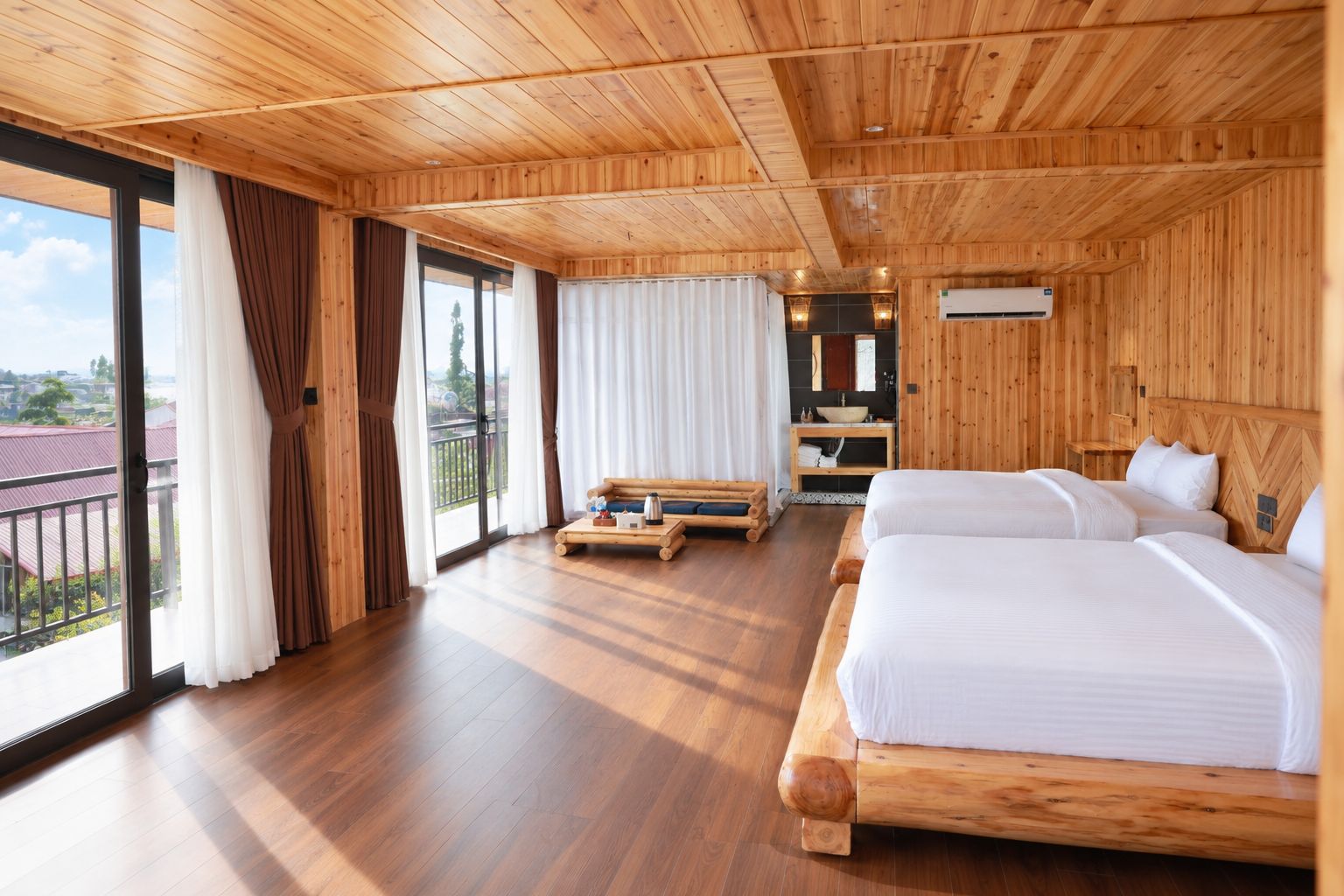A wooden room with a bed, a sofa, and a table. There is a window with curtains and a view of the outside.