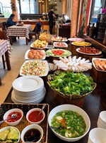 A buffet with various dishes and a salad bar.
