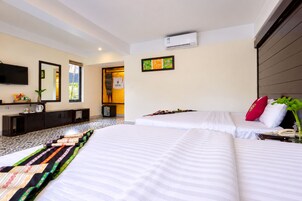 A hotel room with two beds, a TV, a minibar, and a window with a view.