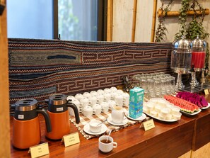 A breakfast buffet with coffee and tea options, a variety of pastries, and a juice bar. - Sapa Village Hotel Sky Lounge & Spa (Sa Pa)