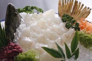 A seafood platter with various types of fish and garnishes.