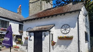 A white building with a black door, flower boxes, and a sign reading "Fresh Pale Ale". - The Weary Friar (Saltash)
