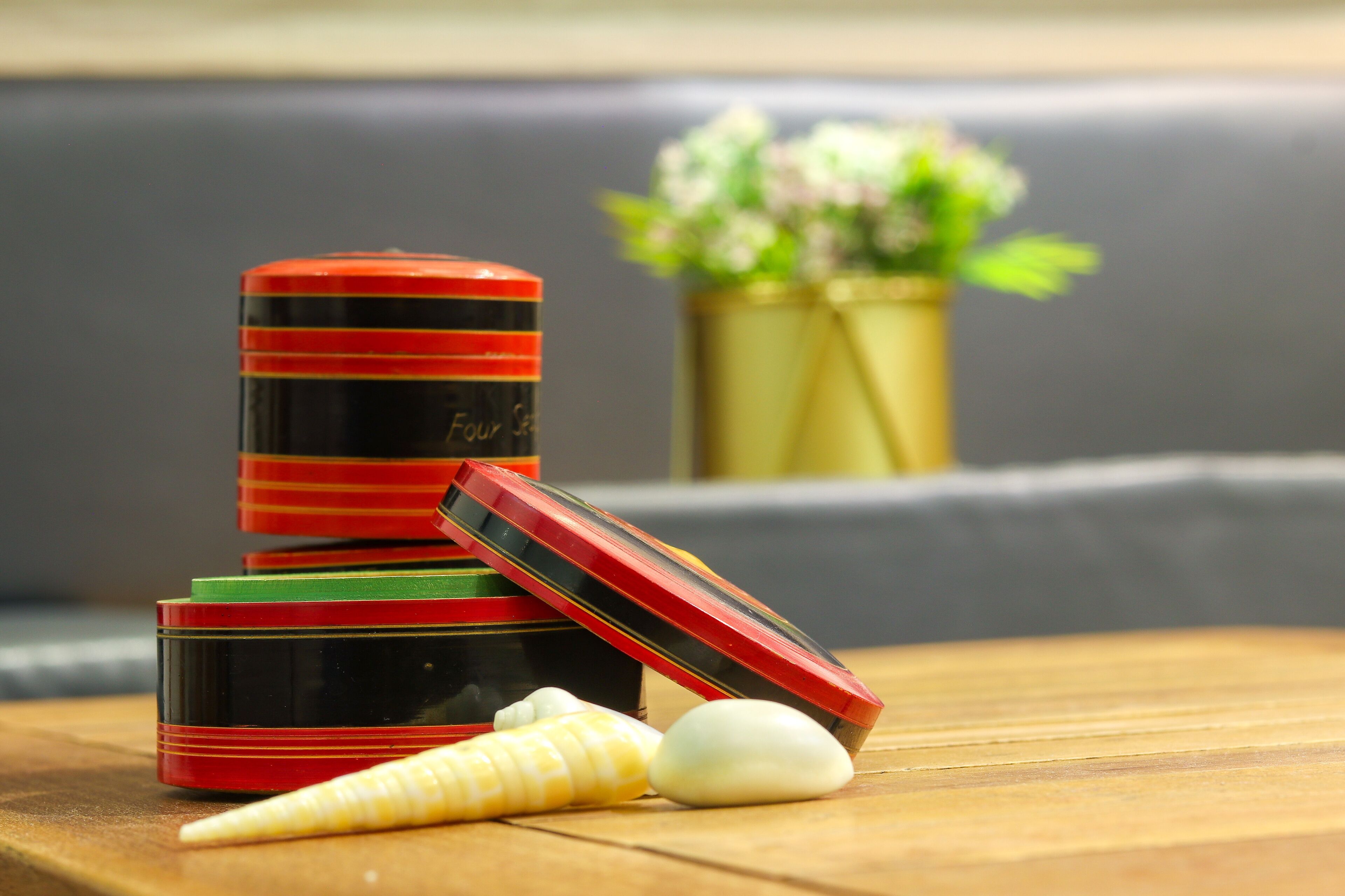A stack of red and black containers with a label that reads "Four Seasons."