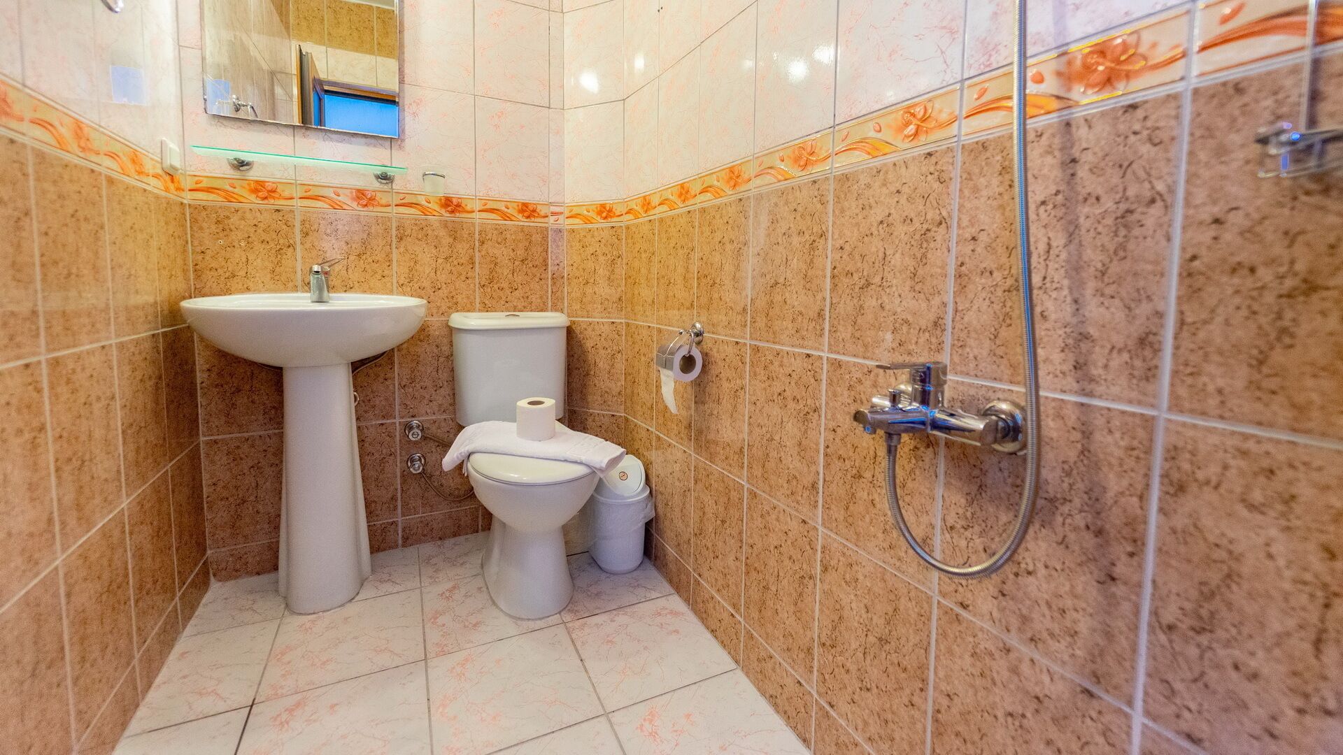 shower, hair dryer, slippers, towels