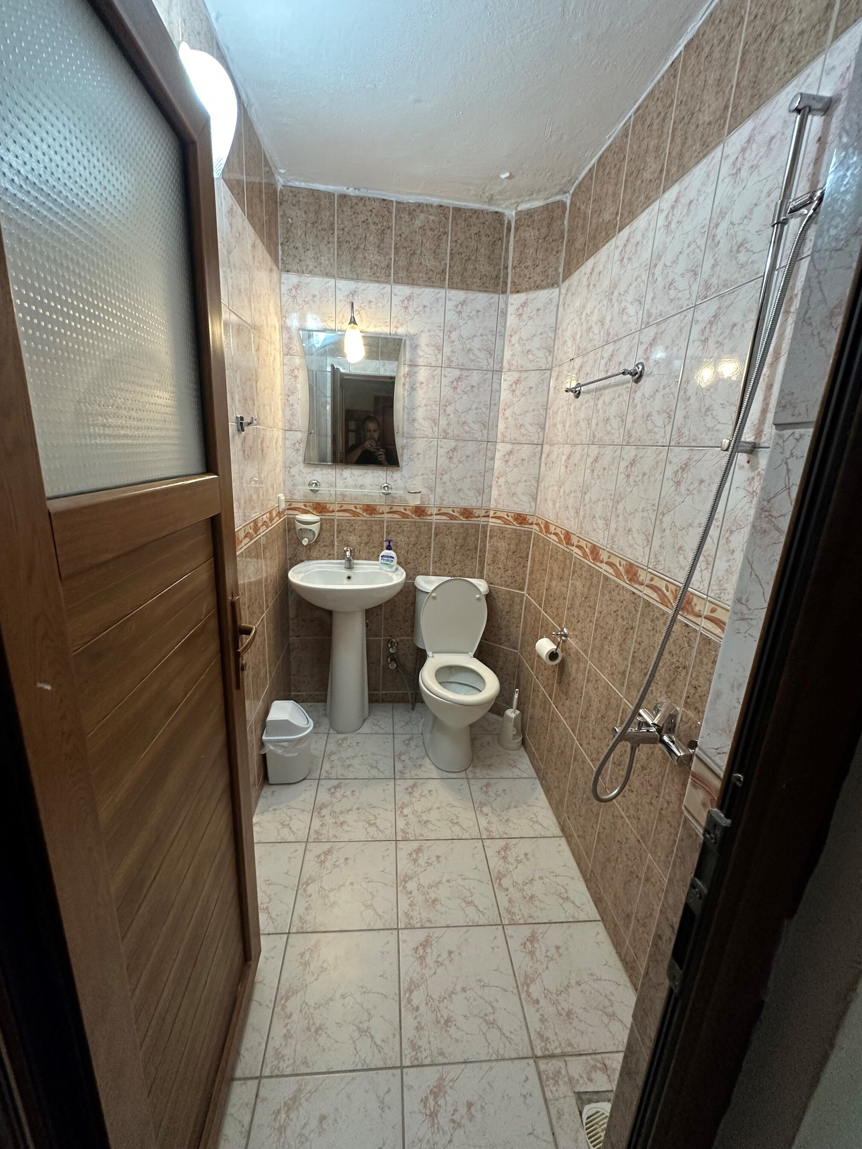 shower, hair dryer, slippers, towels