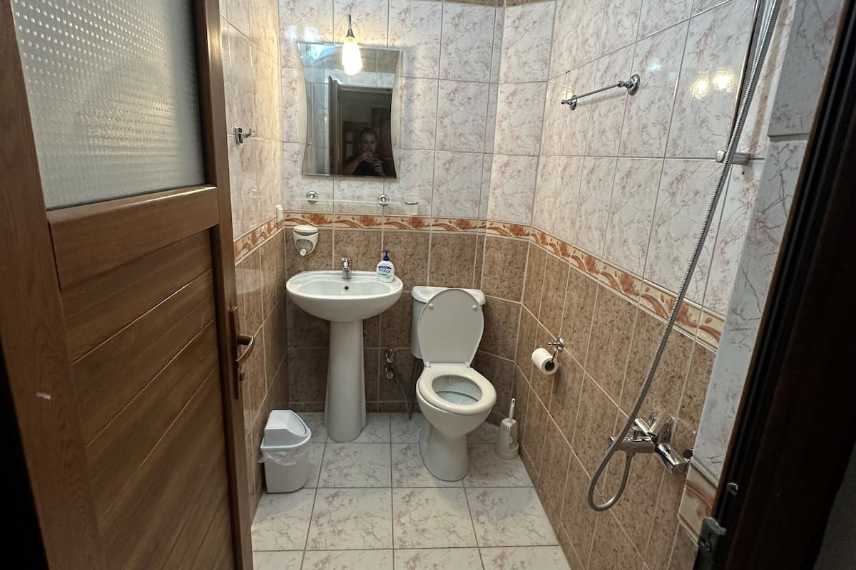 shower, hair dryer, slippers, towels