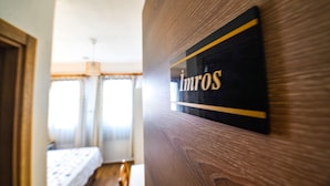 A wooden door with a sign that reads "IMROS". - Bozcaada Hotel Vitis (Bozcaada)