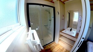 A compact bathroom with a glass shower enclosure, a sink, and a mirror. - Glamping Terre & Mer (Binic-Etables-sur-Mer)