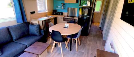 A compact kitchenette with a microwave, stove, and sink.