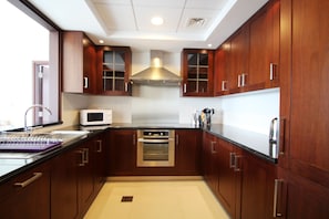 Apartment, 1 Bedroom | Private kitchen | Fridge, microwave, oven, stovetop - Kennedy Towers - 29 Boulevard (Dubai)