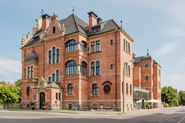A large, historic brick building with arched windows and a prominent entrance. - Craft Beer Central Hotel (Gdansk)