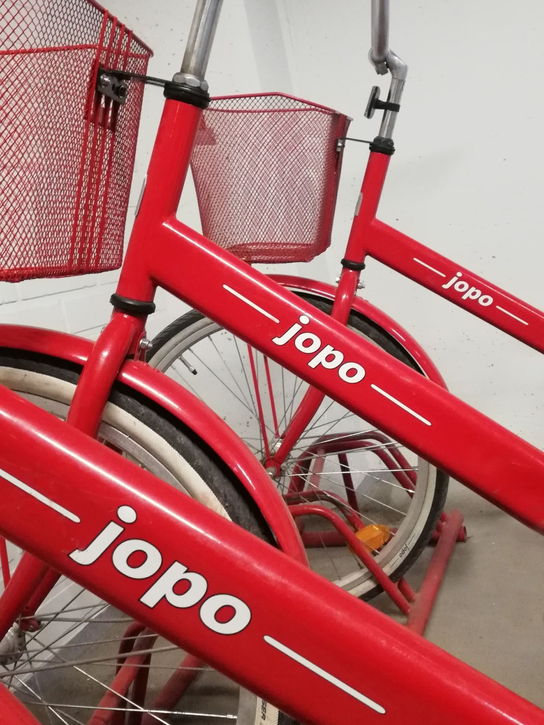 A red bicycle with the brand name "jopo" on the frame.