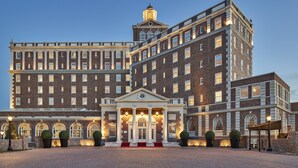 A large, historic hotel with a grand entrance, multiple floors, and a prominent tower. - The Historic Cavalier Hotel and Beach Club, Autograph Collection (Virginia Beach)
